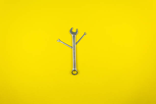 istock Set of wrenches of different sizes on a yellow background 1221218324