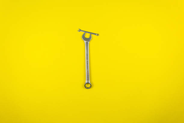 istock Set of wrenches of different sizes on a yellow background 1221218338