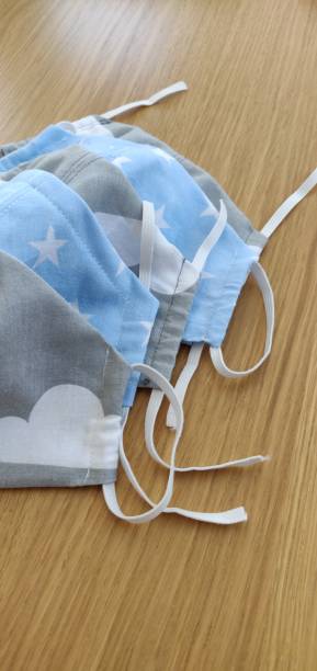 istock Self-sewing protective masks. Homemade protective mask and pieces of cloth on table 1221218652