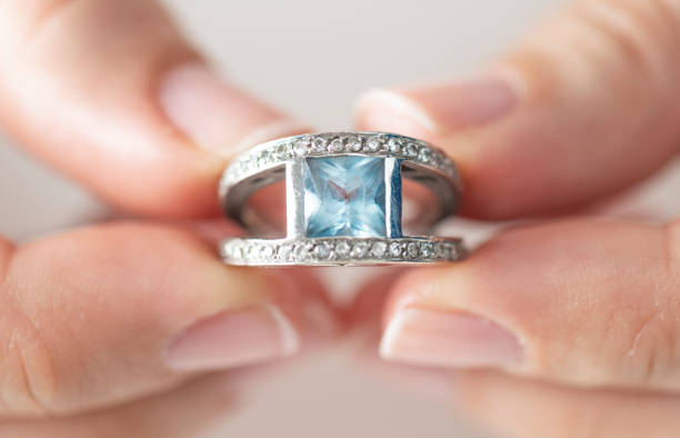 istock Woman Holding a Diamond Ring 1221222979