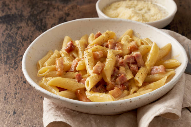 pâtes carbonara. penne à la pancetta, oeuf, parmesan et sauce à la crème. - penne photos et images de collection