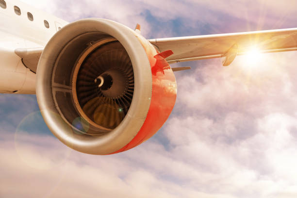 istock Airplane Flying in Sunset Clouds With Lens Flare and Copy Space 1221224433