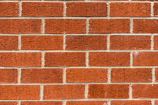 Close up of a red brick wall with even spacing