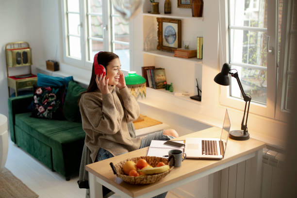 istock Happy young woman working from home on a laptop 1221226545