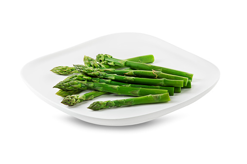 Asparagus. Green asparagus. Fresh boiled Asparagus on plate isolated on white
