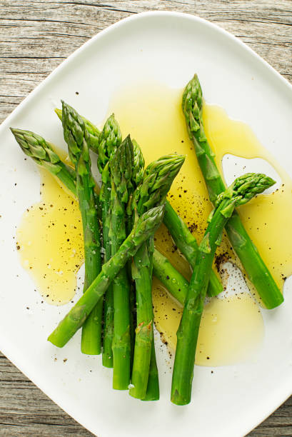istock Fresh boiled Asparagus with sauce on plate 1221227145