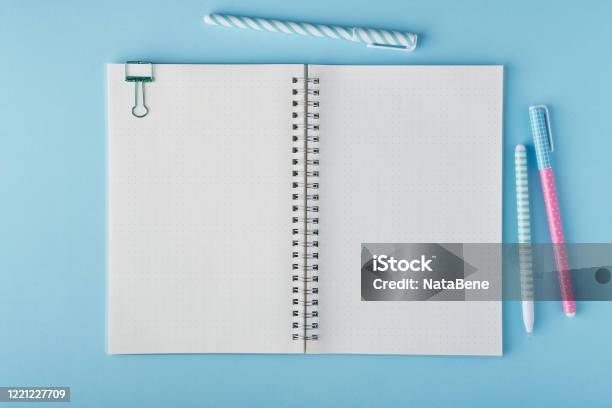 Blank Notepad Page In Bullet Journal On Bright Blue Office Desktop Stock Photo - Download Image Now