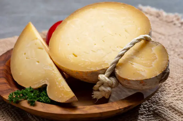 Italian semi hard matured caciocavallo cheese, handmade and aged in natural underground caves in Apulia region close up