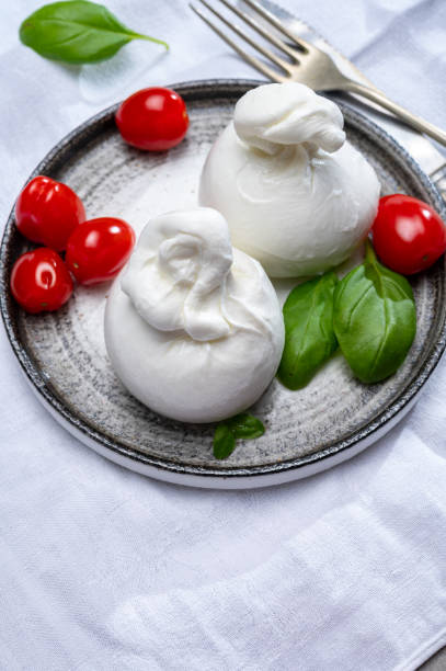 istock Cheese collection, fresh soft white burrata cheese ball made from mozzarella and cream from Apulia, Italy 1221233075
