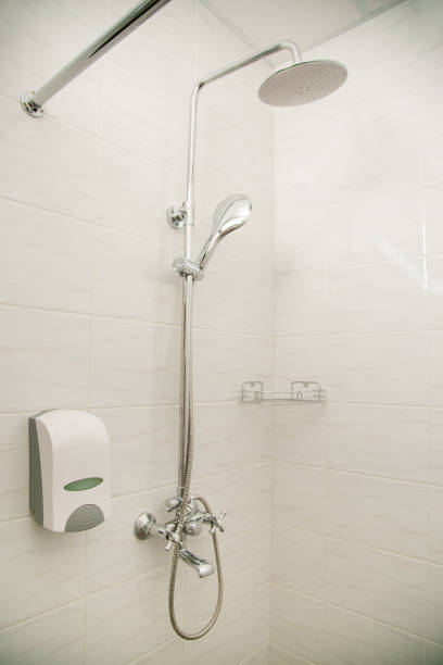istock Bright white-tiled rain shower with rain shower. 1221233125