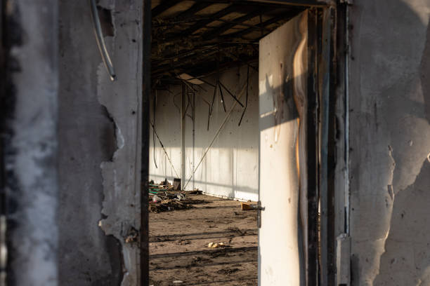 istock view through an open door to a burnt room after a fire. 1221233807