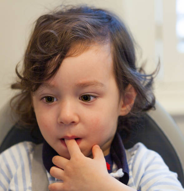 istock Pensive young boy in a high chair 1221233959