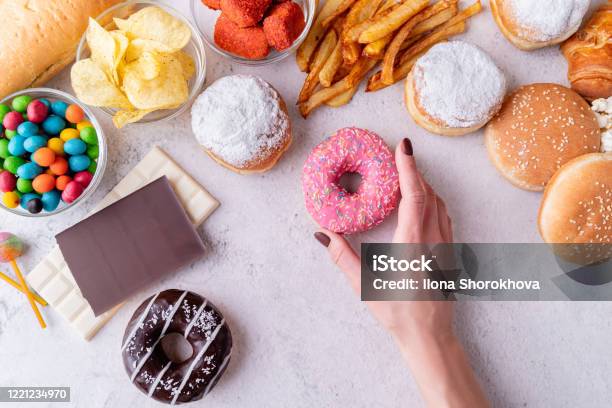 Unhealthy Food And Fast Food With Donuts Chocolate Burgers And Sweets Top View Stock Photo - Download Image Now
