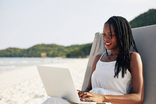 Woman relaxing and working on laptop