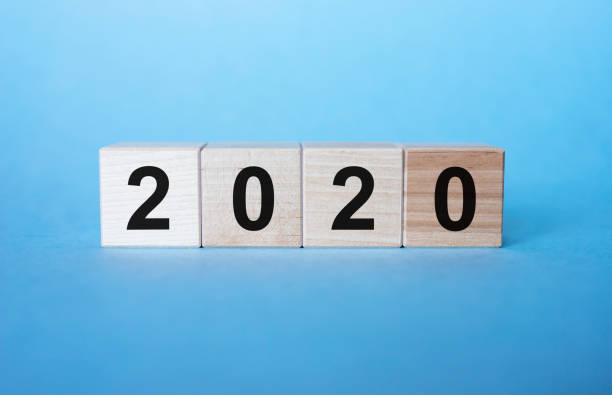 istock Year 2020 sign on a wooden cubes ion blue background 1221236307