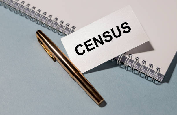 istock CENSUS word on white paper with golden pen and white notepad on grey blue table 1221236312