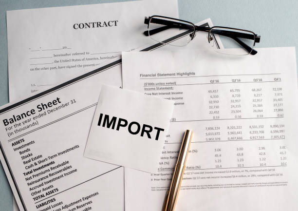 istock Import Word Written on white sticker and glasses on documents 1221236356