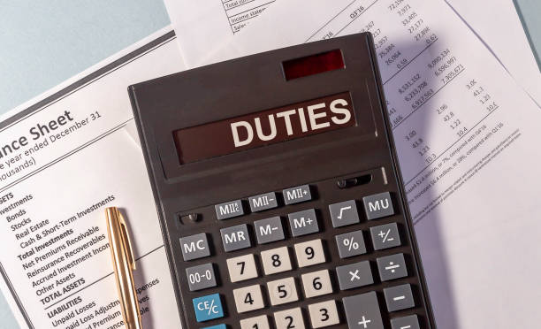 istock Word DUTIES on calculator with pen glasses on documents 1221236365