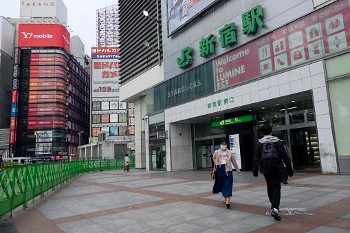 Shinjuku, Tokyo, Japan - April 26, 2020: Fewer visitors in the streets. Shinjuku station is well known as the world's busiest train station. It became empty after state-of-emergency declaration due to COVID-19 crisis (Coronavirus)