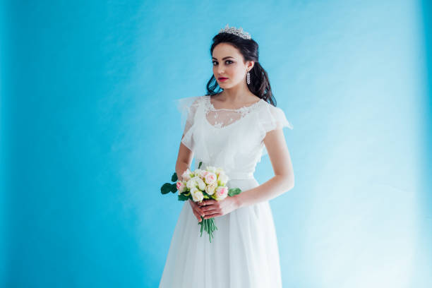 istock Princess Bride in a white dress with a Crown on a blue background 1221236660