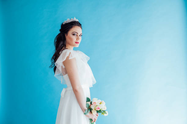 istock Princess Bride in a white dress with a Crown on a blue background 1221236673