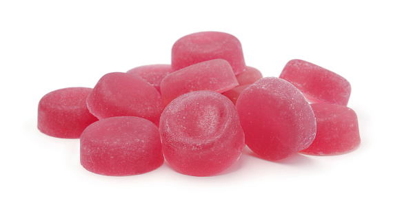 A pile of fruit red candies isolated on white background.