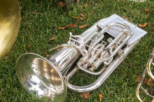 Silver euphonium isolated in the grass.