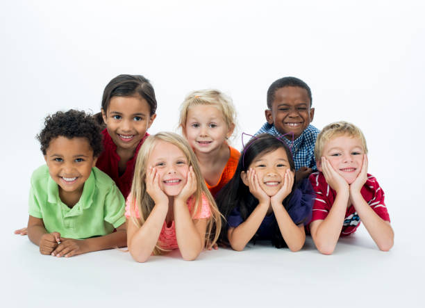 istock Happy Kids Laying in a Row Smiling 1221237552