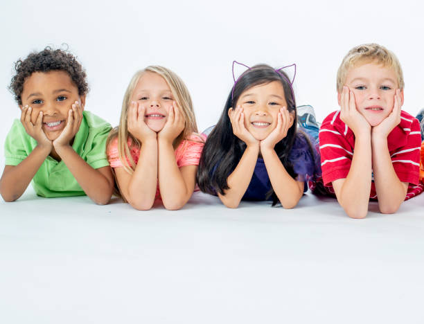 istock Happy Kids Laying in a Row Smiling 1221237556