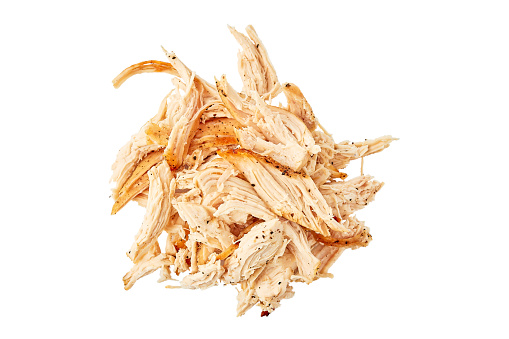 Heap of pulled chicken meat isolated on white background. Top view, clipping path included