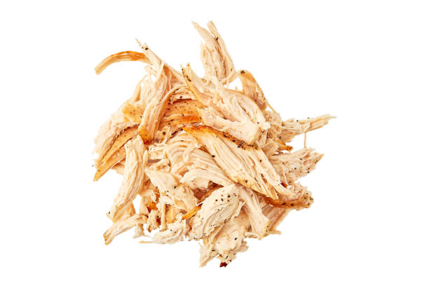 Heap of pulled chicken meat on white Heap of pulled chicken meat isolated on white background. Top view, clipping path included shredded stock pictures, royalty-free photos & images