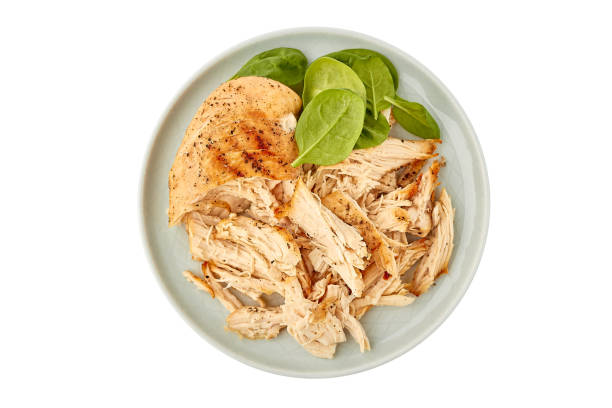 Plate with pulled chicken breast on white stock photo