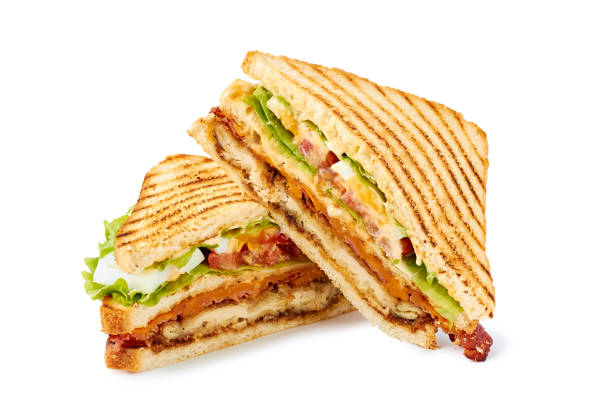 Two halves of club sandwich on white Two halves of club sandwich isolated on white background. Clipping path included sandwich stock pictures, royalty-free photos & images