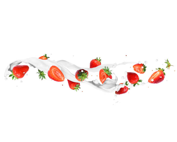 istock Whole and sliced strawberries with milk splashes 1221238860