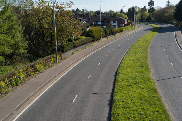 istock Empty dual carriageway running through a suburban residential district 1221240470