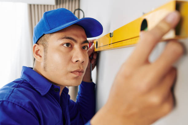 istock Repairman measuring wall 1221240828