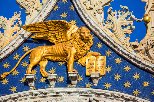 The pediment is decorated with a golden winged Lion - the emblem of Venice. San Marco Cathedral - architectural masterpiece in the Byzantine style. The concept of cultural and photo tourism