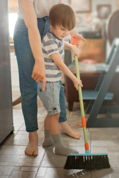 istock Family brushing floor at home 1221244214