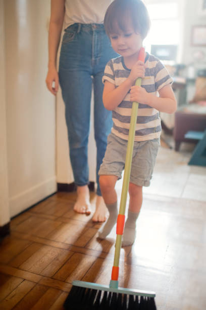 istock Family brushing floor at home 1221244809