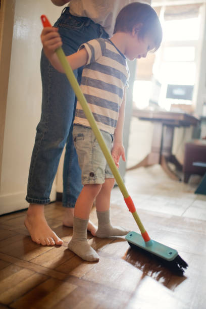 istock Family brushing floor at home 1221244812