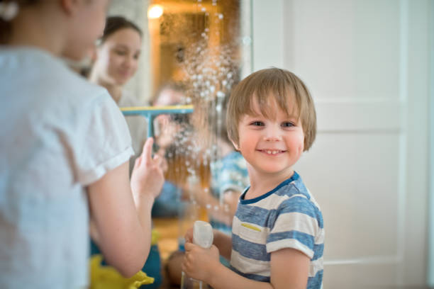 istock Family cleaning mirror during housekeeping 1221245453