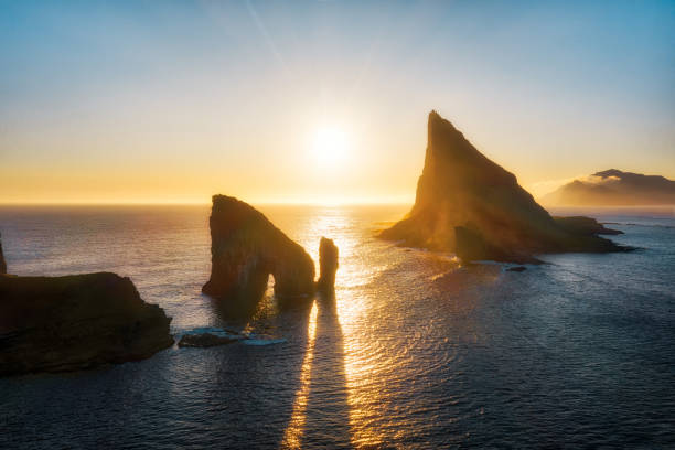 Drangarnir Rocks during Sunset in the Faroe Islands, Denmark Drangarnir Rocks during Sunset in the Faroe Islands, Denmark, post processed in HDR vágar photos stock pictures, royalty-free photos & images