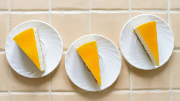 istock Top view three cheesecakes with orange frosting. 1221252883