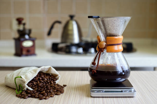 istock Coffee maker with filter and coffee beans on a wooden surface. 1221253517