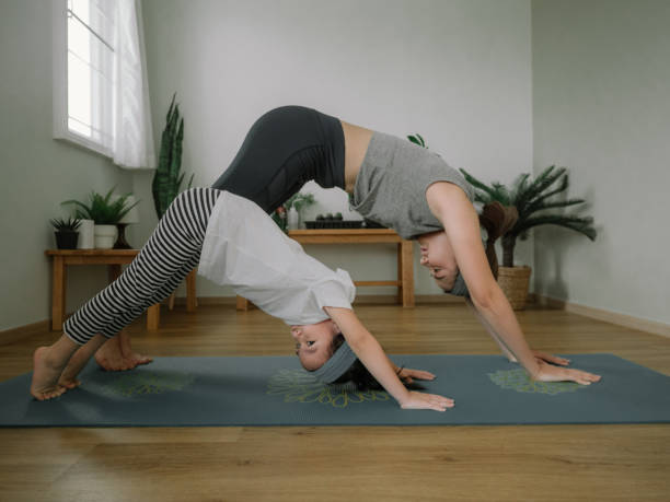 istock Mother and daughter doing yoga 1221256296