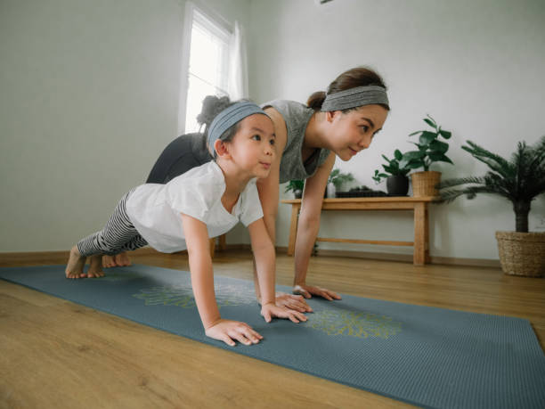 istock Mother and daughter doing yoga 1221256322