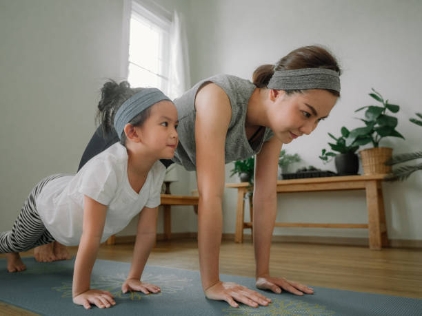 istock Young mother and daughter making a exercises at home. 1221256329