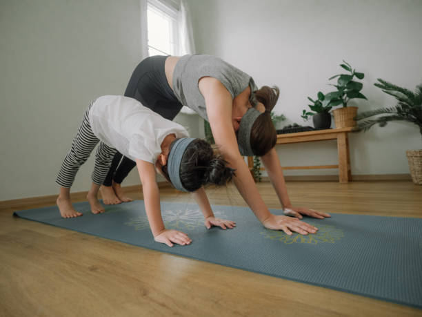 istock Young mother and daughter making a exercises at home. 1221256334