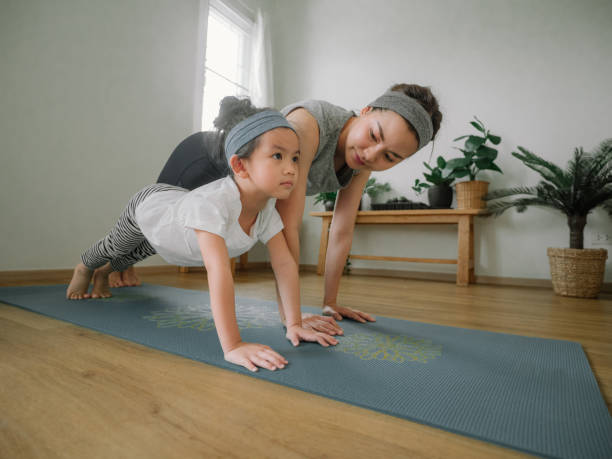 istock Young mother and daughter making a exercises at home. 1221256349