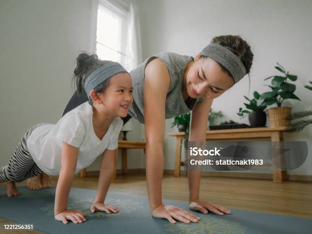 Mother And Daughter Doing Yoga Stock Photo - Download Image Now - Exercising, Family, Child